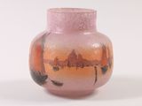 a pink vase with a picture of boats on it