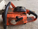 a chainsaw that is sitting on the ground
