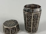 two pieces of silverware sitting next to each other on a white surface