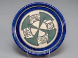 a blue and white plate with a design on it