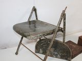 an old metal chair that is sitting on a table
