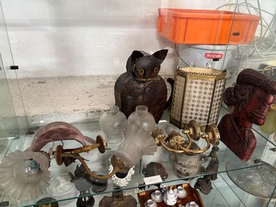 a glass display case filled with various glass items