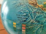 a blue globe with a map on it sitting on a table