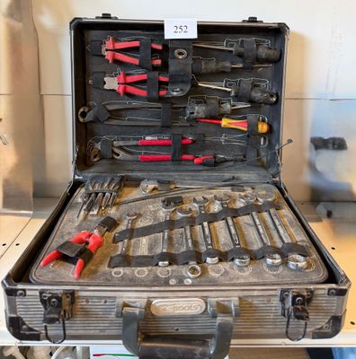 a suitcase with tools in it sitting on a table