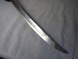 a large knife that is laying on a table