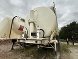 a cement truck that is parked on the side of the road