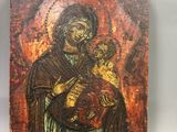 an old wooden icon of a woman holding a child