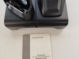 an image of a pair of headphones sitting on top of a charging dock