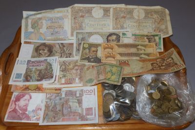 a tray full of money and coins sitting on a table