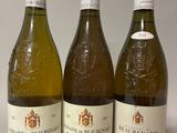 trois bouteilles de vin posées sur une table l'une à côté de l'autre