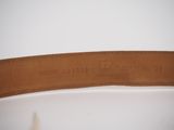 a close up of a brown leather belt with a white background