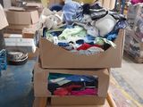 un tas de vêtements dans une boîte en carton posée sur un carton