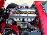a close up of a red car engine with its hood open