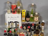 many different bottles of alcohol on the table