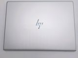 the back of a laptop computer sitting on top of a white table