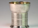 a silver cup that is sitting on a table