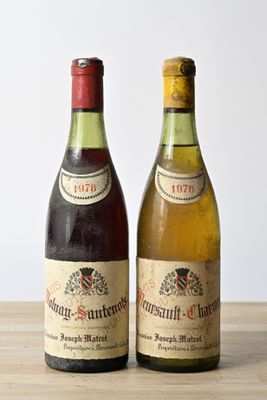 two bottles of wine sitting on top of a table next to each other
