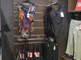a display of clothing in a clothing store with clothes on hangers