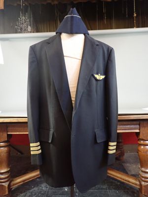 a suit and tie on a mannequin stand in front of a table