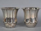 pair of silverplated vases on a grey background