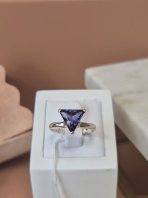 a white box with a ring inside of it on a table