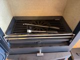 a black stove top with a metal grate on it