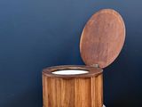 a wooden stool with a bowl on top of it