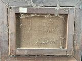an old picture frame with a piece of wood in it sitting on a table