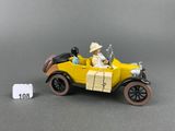 a yellow toy car with a man and a woman in it