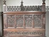 a wooden bench with carvings on it in a room