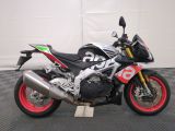 a motorcycle that is parked on a black and white checkered floor