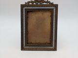 an old picture frame with a picture of a bird on it