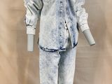 jean jacket and pants on a mannequin stand against a white backdrop