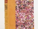 an old book with a floral design on the front cover