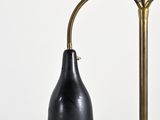 an image of a black and gold lamp on a white wall