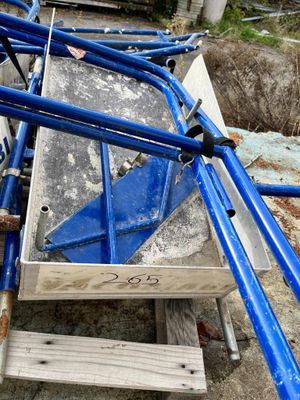 a pile of blue pipes sitting on top of a wooden bench