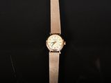 a close up of a watch on a black surface