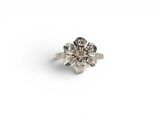 a close up of a diamond ring on a white surface