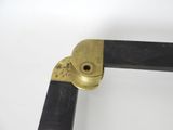 a close up of a metal object with a black handle