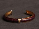 a close up of a bracelet on a black surface