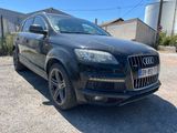 the black audi qx is parked in the parking lot