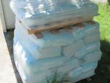 a pile of bags of toilet paper on the ground