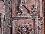 a wooden door with carvings on it in a room