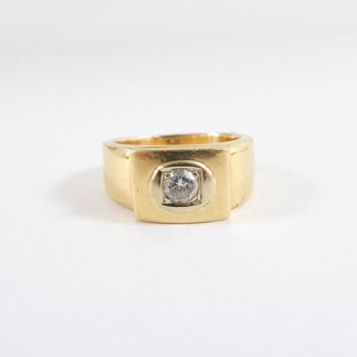 a close up of a gold ring with a diamond in the center