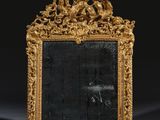 an antique mirror with a gold frame on a black background
