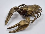 brass plated lobster on a white background