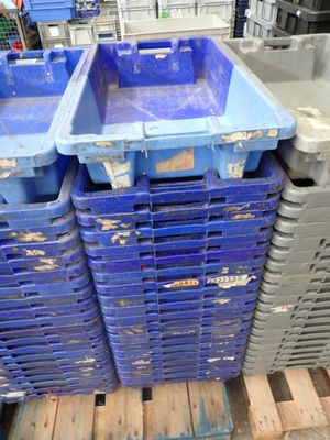several blue plastic containers stacked on top of each other on a pallet