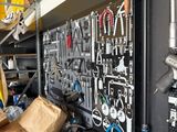 many tools hanging on the wall in the garage