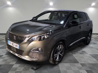 the front view of a dark colored suv parked in a room