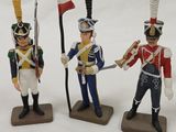 three figurines of soldiers with flags and flags on a white surface
